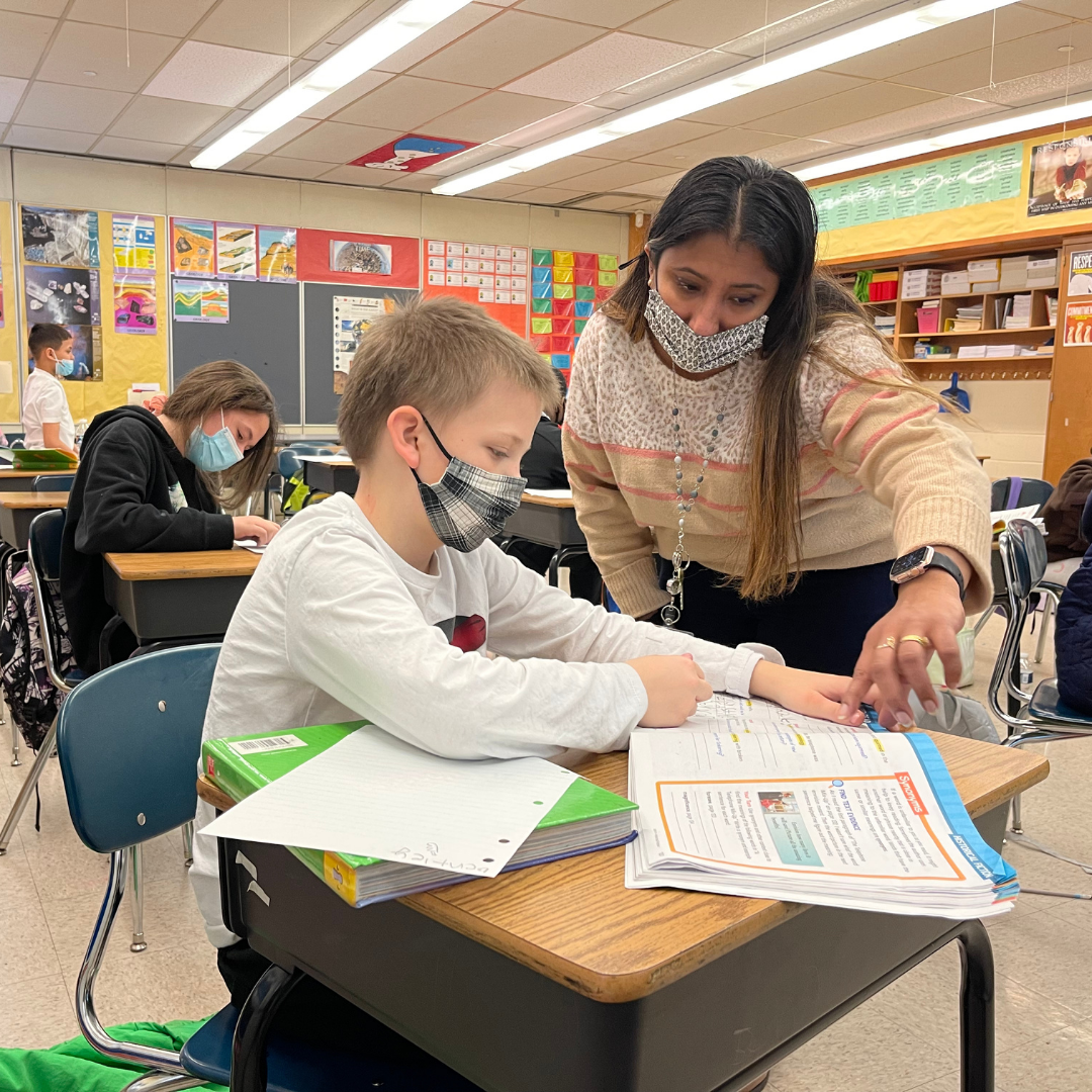 Teacher works with student